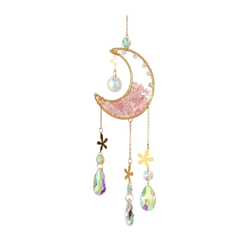 Decorative hanging ornament with pink crescent moon, crystals, and flowers on a white background