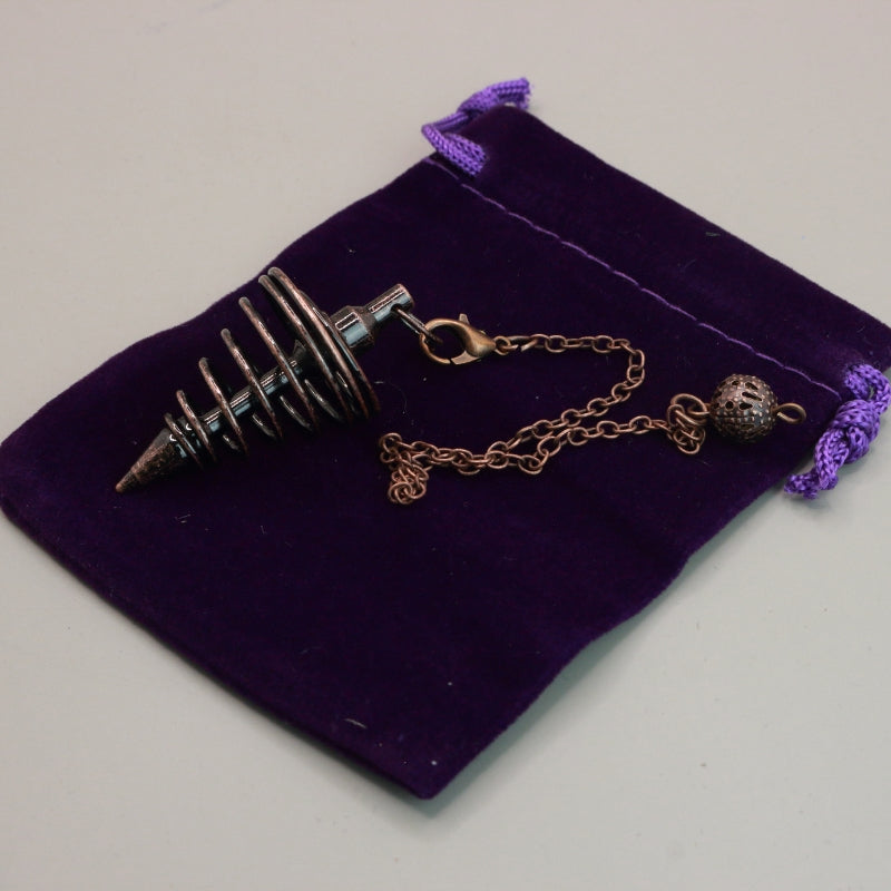 antique copper spiral pendulum on purple velvet pouch