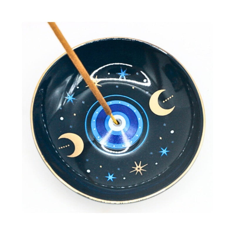 Incense burner with evil eye design and incense stick on a white background