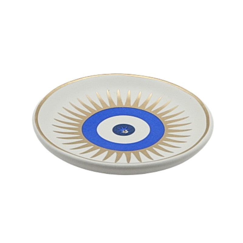 Decorative plate with blue center and gold sunburst pattern on a white background
