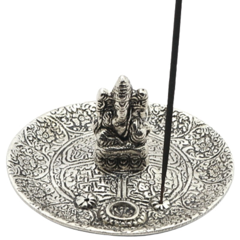 incense stick on an aluminium incense burner with ganesh in the centre