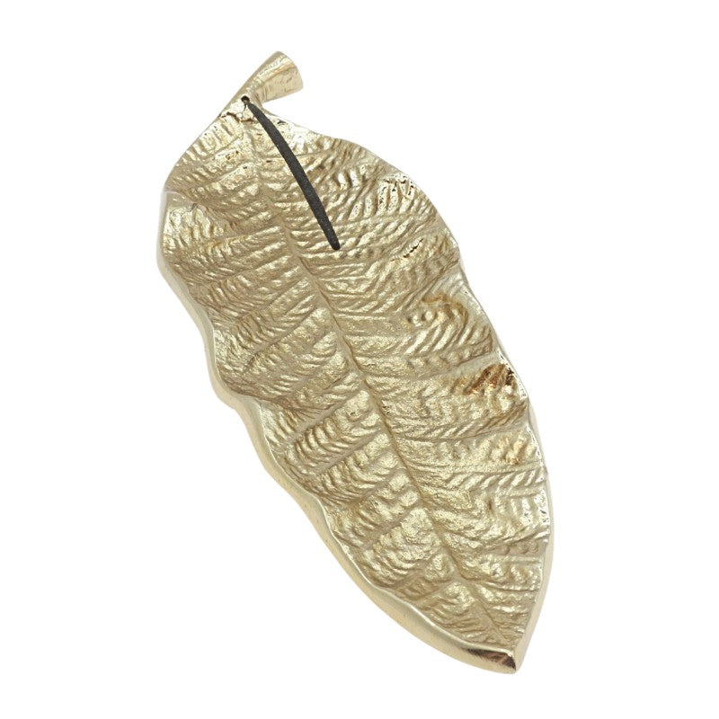 gold incense holder in the shape of a leaf holding a natural incense stick