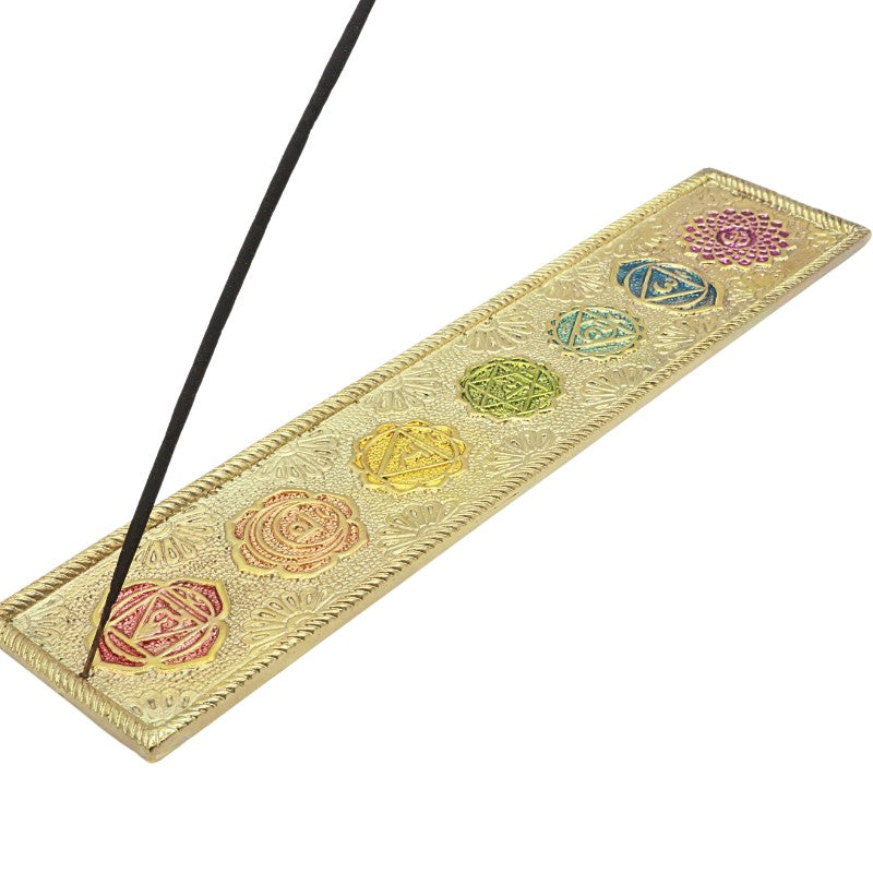 incense stick in a golden coloured chakra incense holder