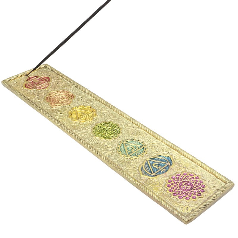 incense stick in a golden coloured chakra incense holder