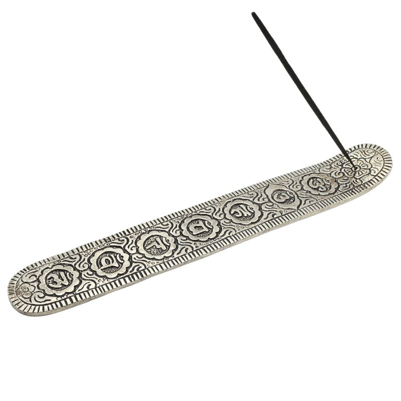 incense stick in an aluminium incense burner with chakra symbols etched into top