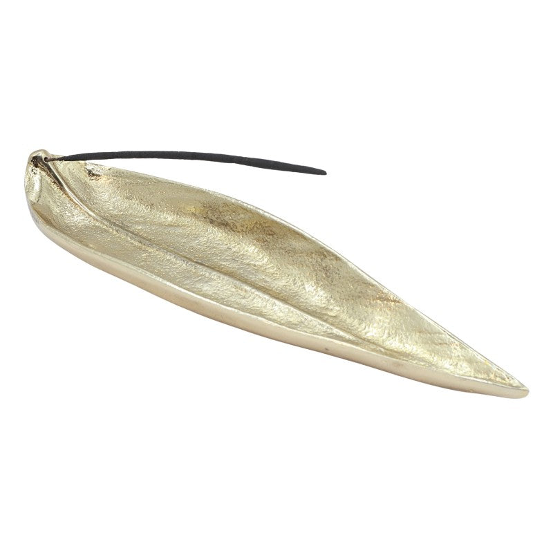 incense stick in a gold, leaf shaped incense burner