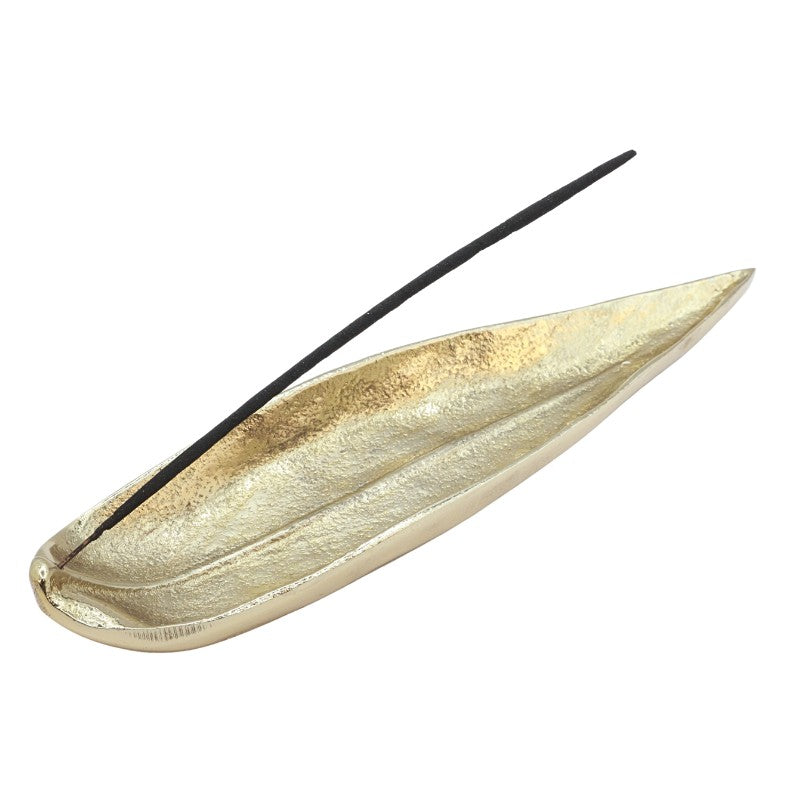 incense stick in a gold, leaf shaped incense burner