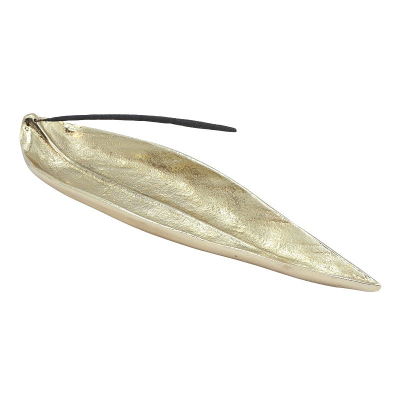 incense stick in a gold, leaf shaped incense burner