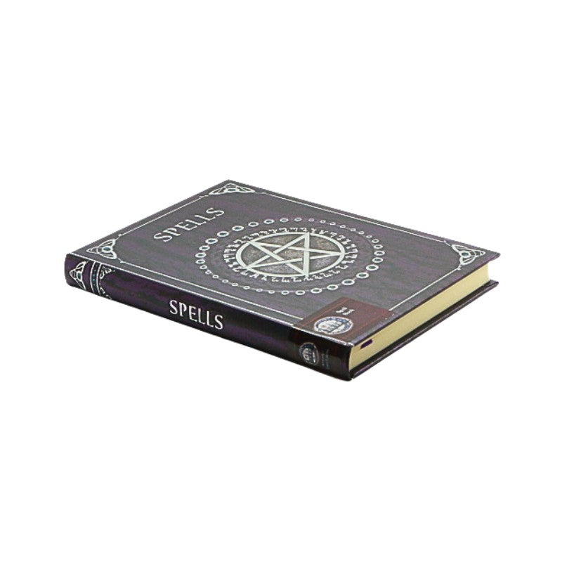 Book titled 'Spells' with a pentagram design on a white background