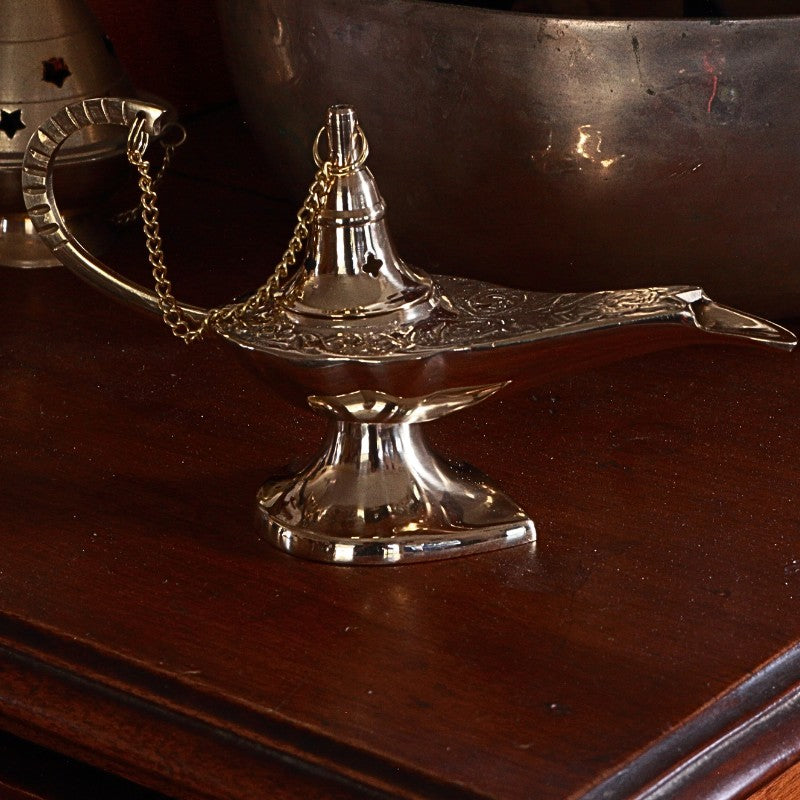 Brass genie lamp on a wooden surface