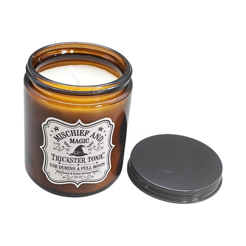 Brown Amber Glass jar with a white label and a witches hat design next to a black lid
