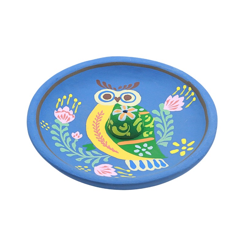 incense burner with colourful owl design on a blue background