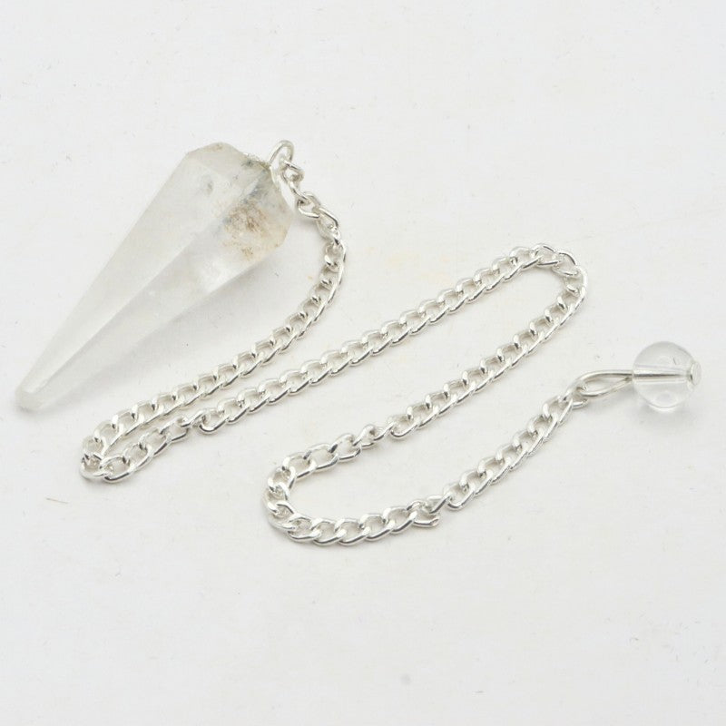 Clear crystal pendulum with silver chain on a white background