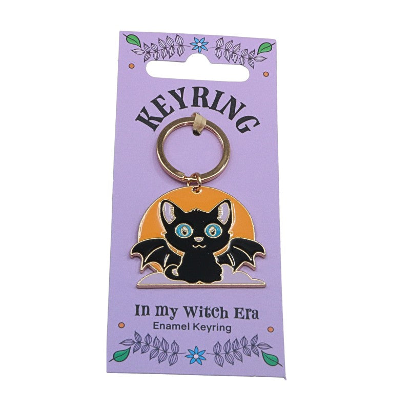 keyring of a bat cat in front of a moon