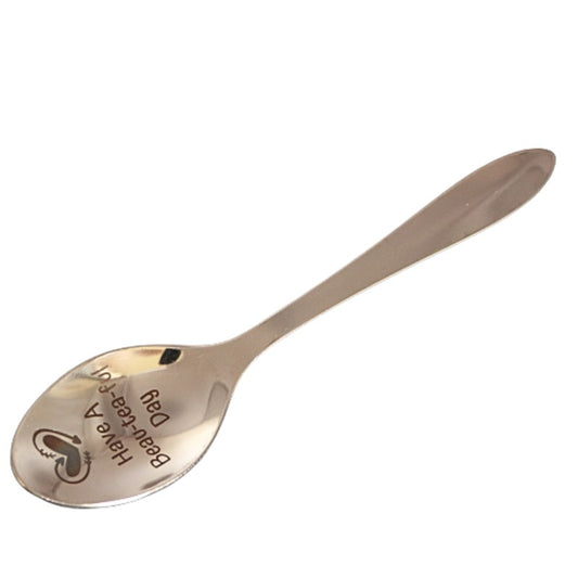 stainless steel teaspoon with "have a bea-tea-ful " and a heart engraved in the dish