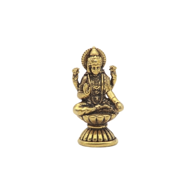 Brass statue of a seated figure on a white background