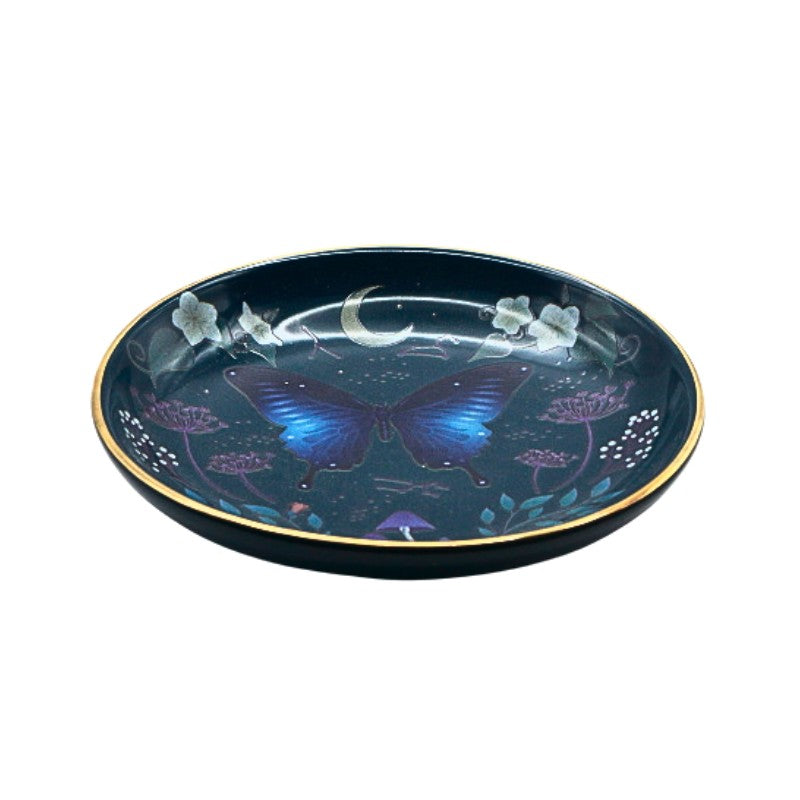 Decorative plate with a blue butterfly design on a dark background