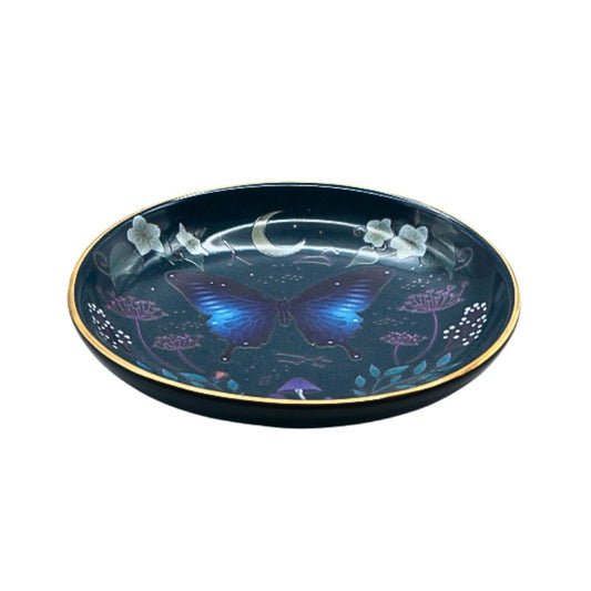 Decorative plate with a blue butterfly design on a dark background