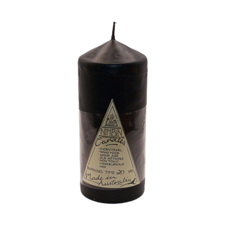 a black pillar candle with a triangle label on the front