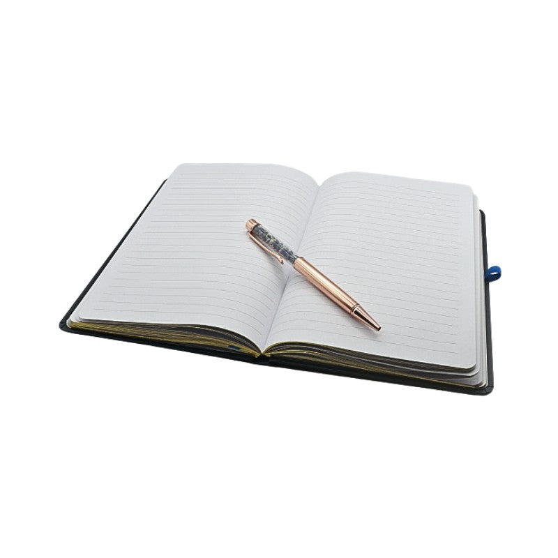 Open notebook with a pen on a white background