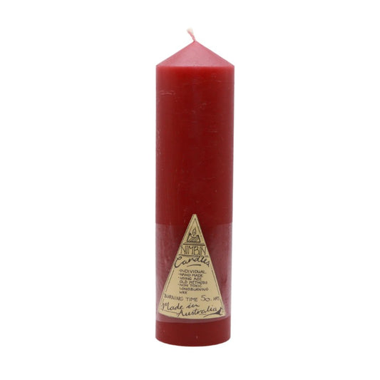 A red pillar candle with a label on its side indicating the brand and type, against a white background.