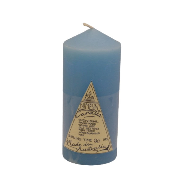 a blue pillar candle with a triangle label on the front