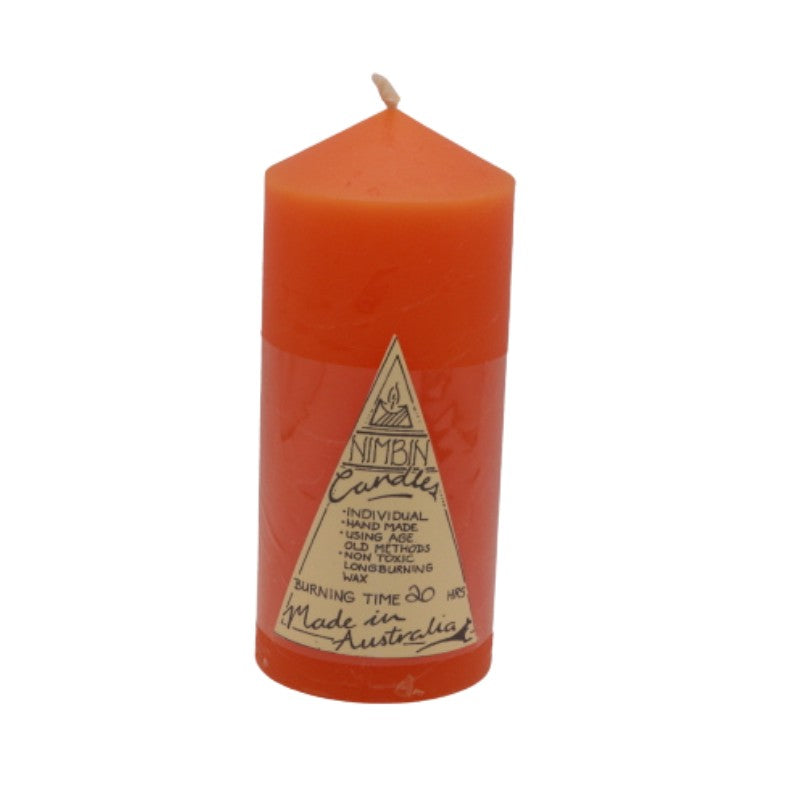 an orange pillar candle with a triangle label on the front