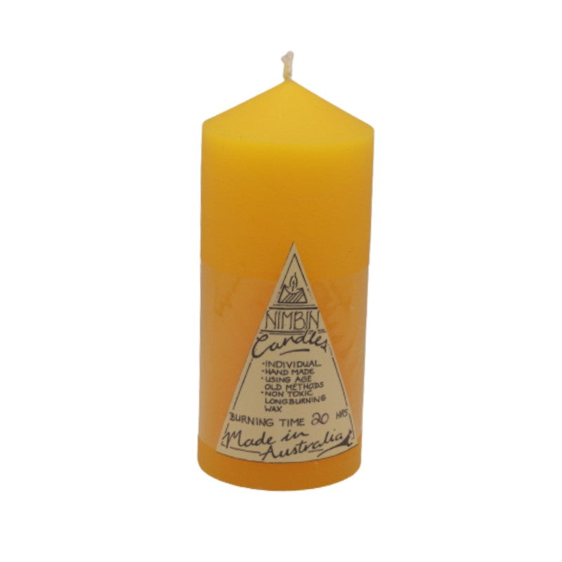 a yellow pillar candle with a triangle label on the front