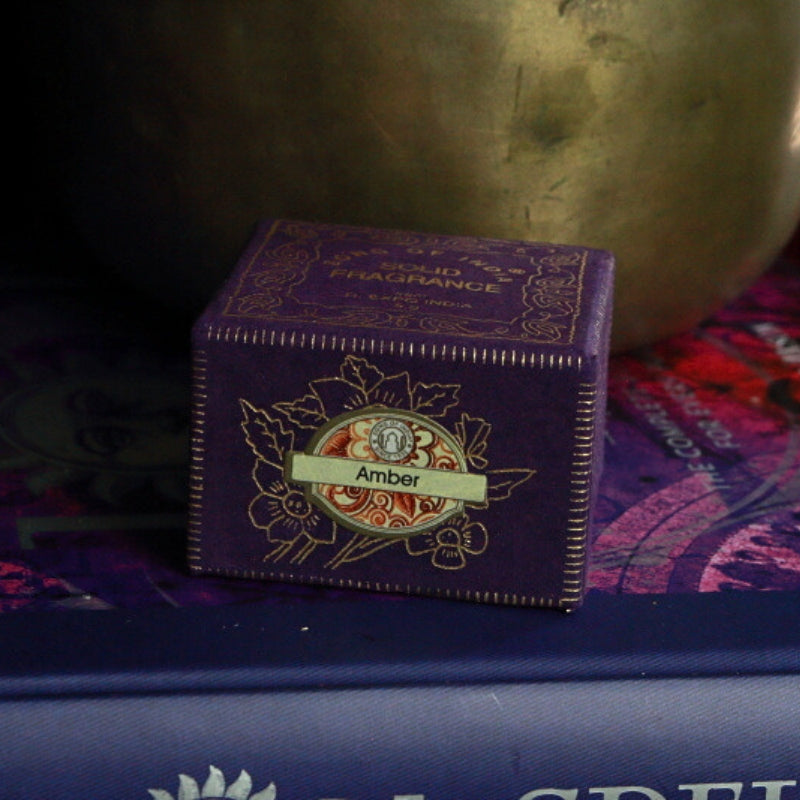 Song Of India Natural Solid Perfume- Amber in front of singing bowl