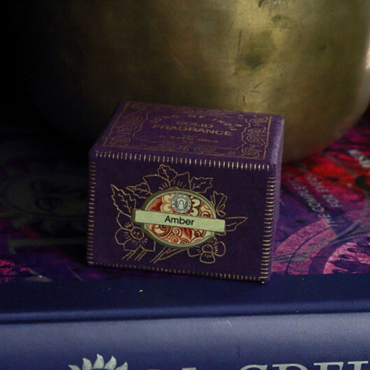 Song Of India Natural Solid Perfume- Amber in front of singing bowl