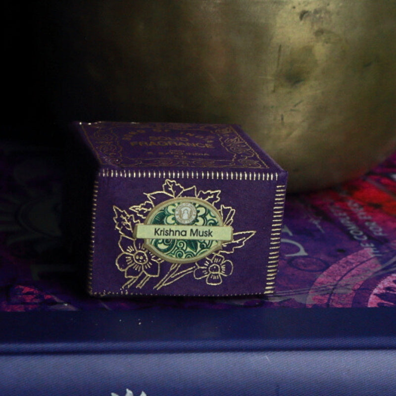 Krishna Musk Song Of India Natural Solid Perfume in front of singing bowl