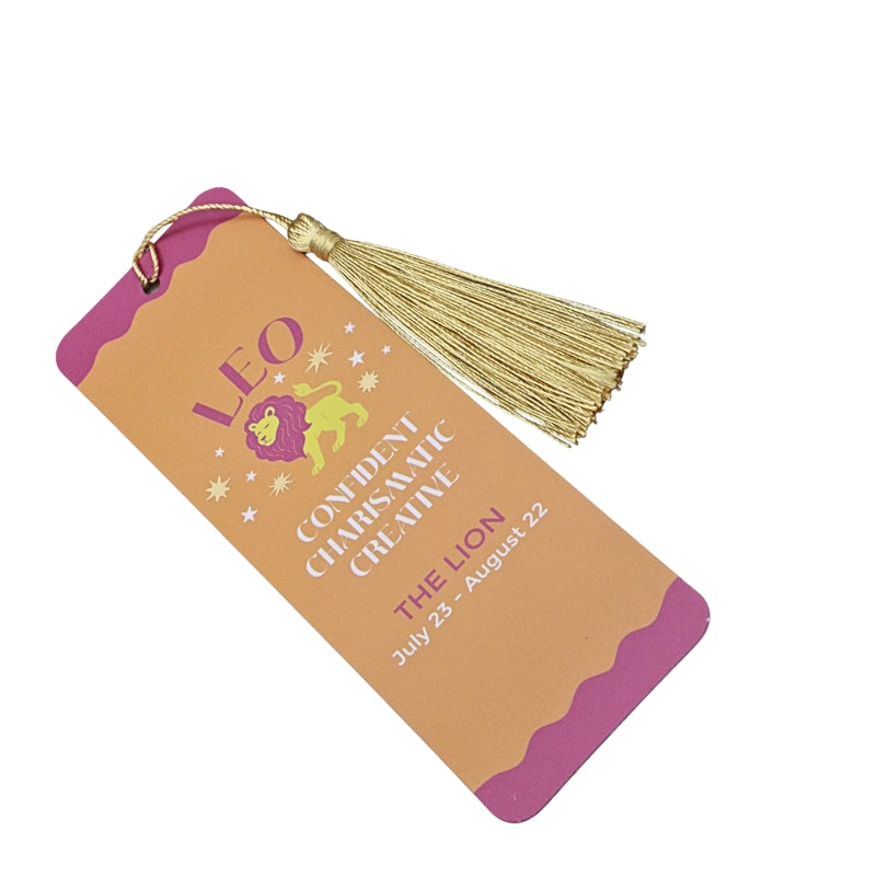 orange and pink bookmark with gold tassel and white and pink writing, on a white background