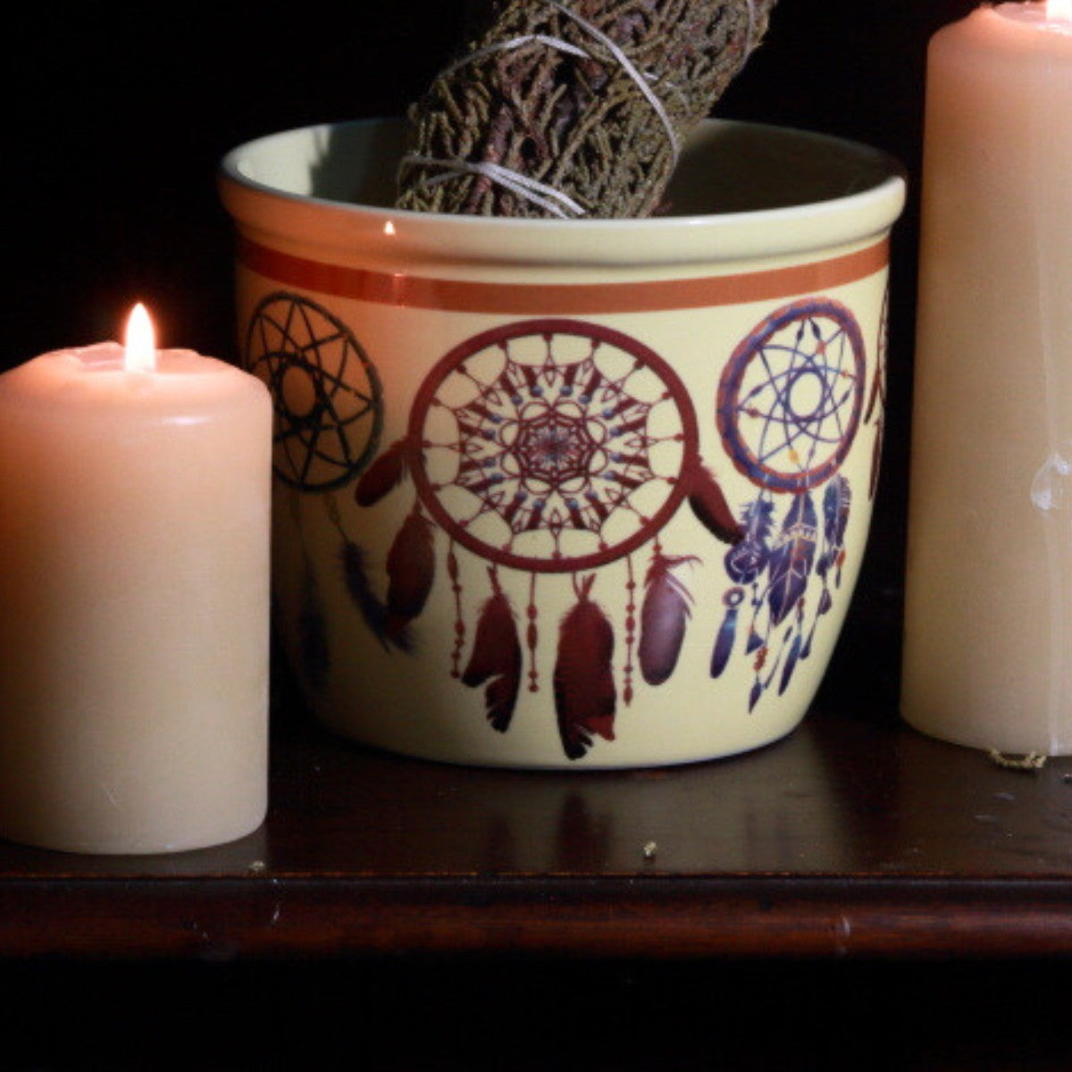 dream catcher smudge bowl next to beeswax candles with a juniper smudge stick