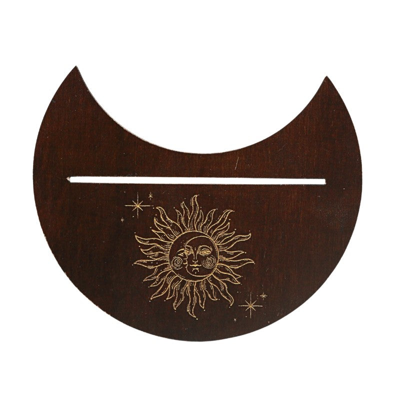 Wooden crescent moon with engraved sun and stars on a white background