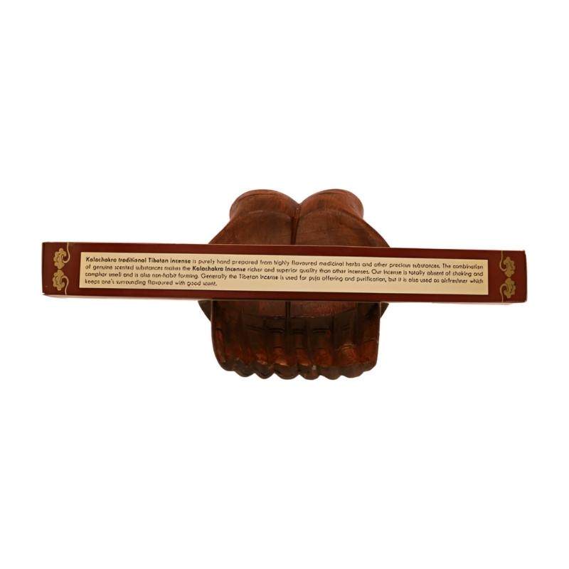 pk of natural tibetan dhoop incense on a pair of open wooden carved hands
