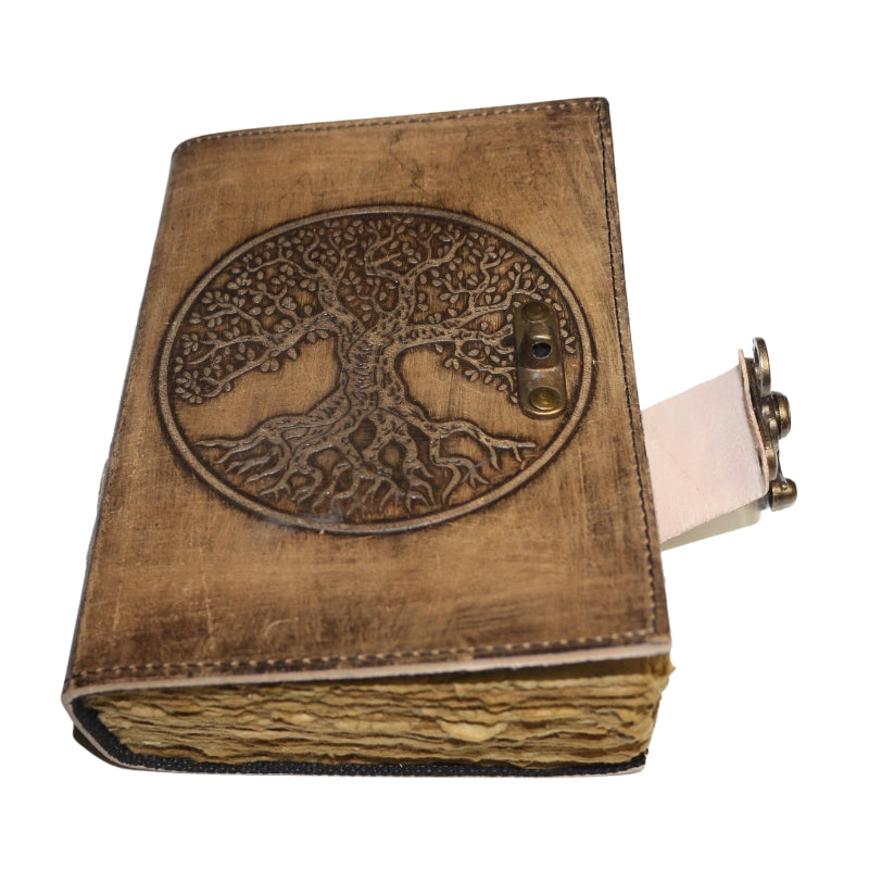Antique style brown leather journal with the tree of life on the cover and a brass closure. Inside contains plain "antiqued" pages