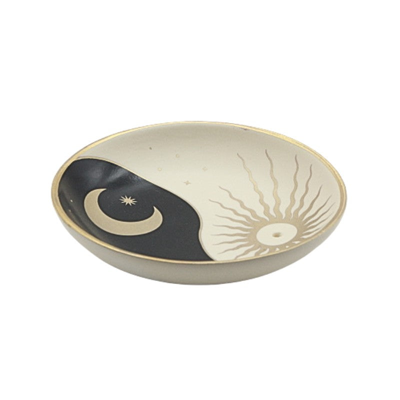 Ceramic incense holder with yin yang design on a white background