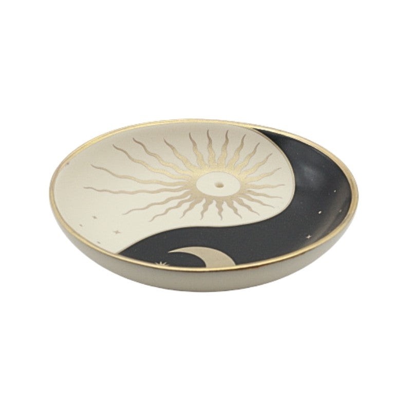 Ceramic incense dish with sun and moon design on a white background