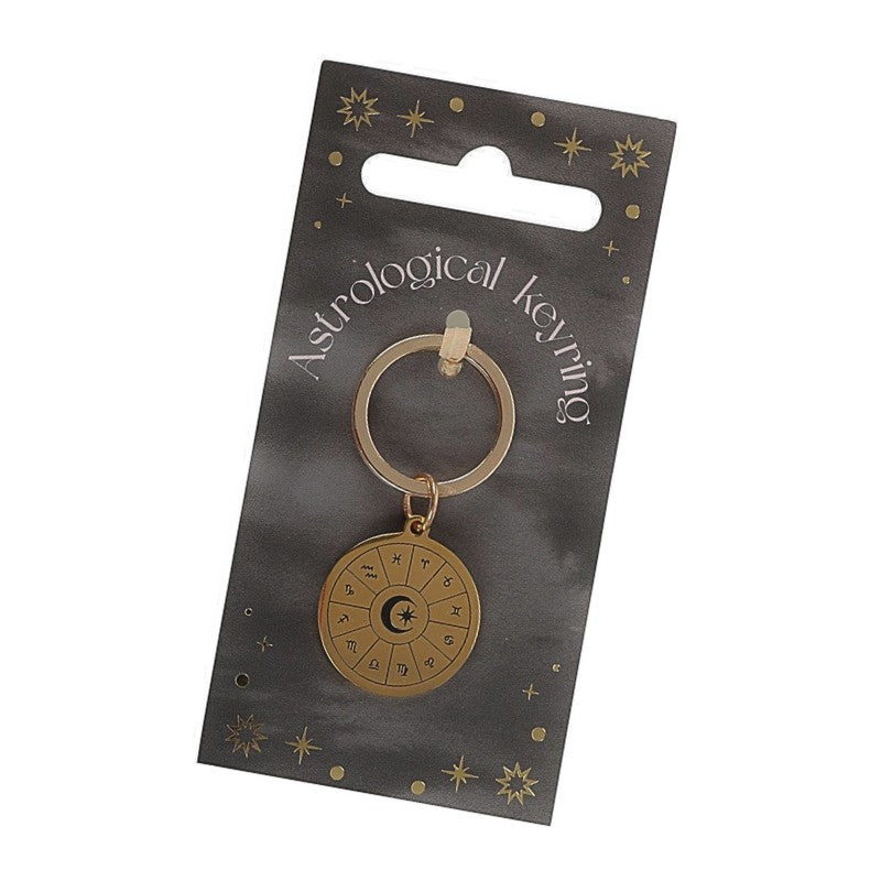 gold coloured keyring with astrology symbols on front