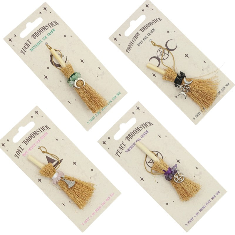 4 tiny hanging broomsticks with charms for