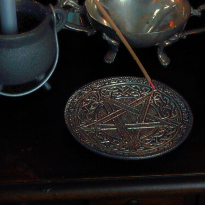 incense stick in an aluminium celtic pentacle design incense holder