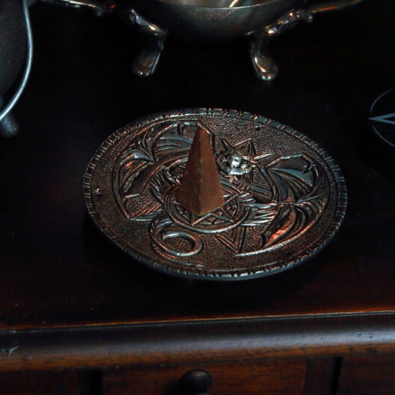 incense cone sitting on top of an aluminium incense holder