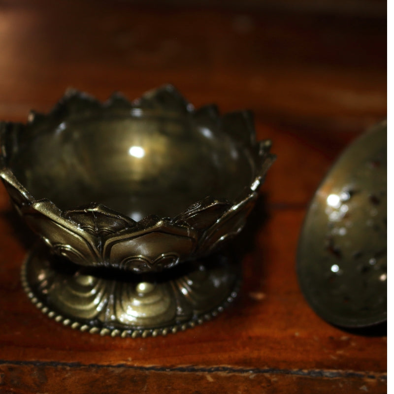 2 piece gold coloured ornate incense holder / censer on wooden table