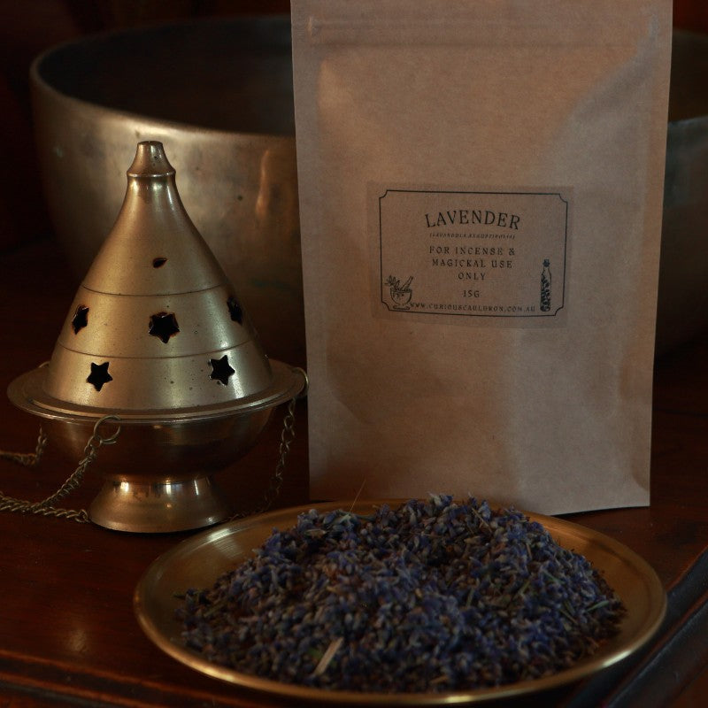 Incense cone holder, lavender incense, and packaging on a wooden surface