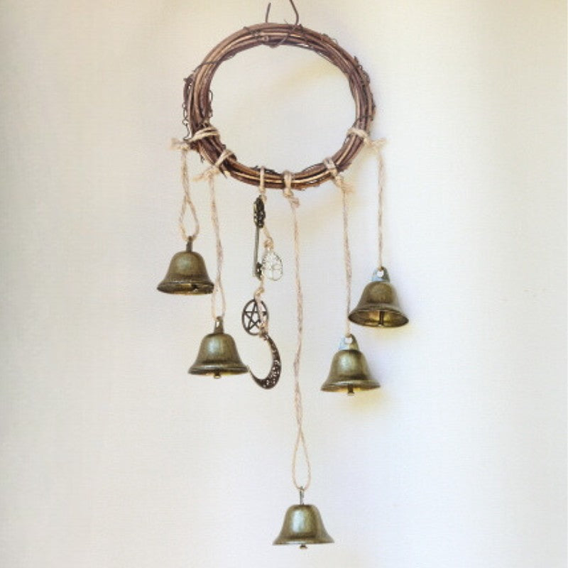 twig wreath with 5 gold bells and charms hanging from it