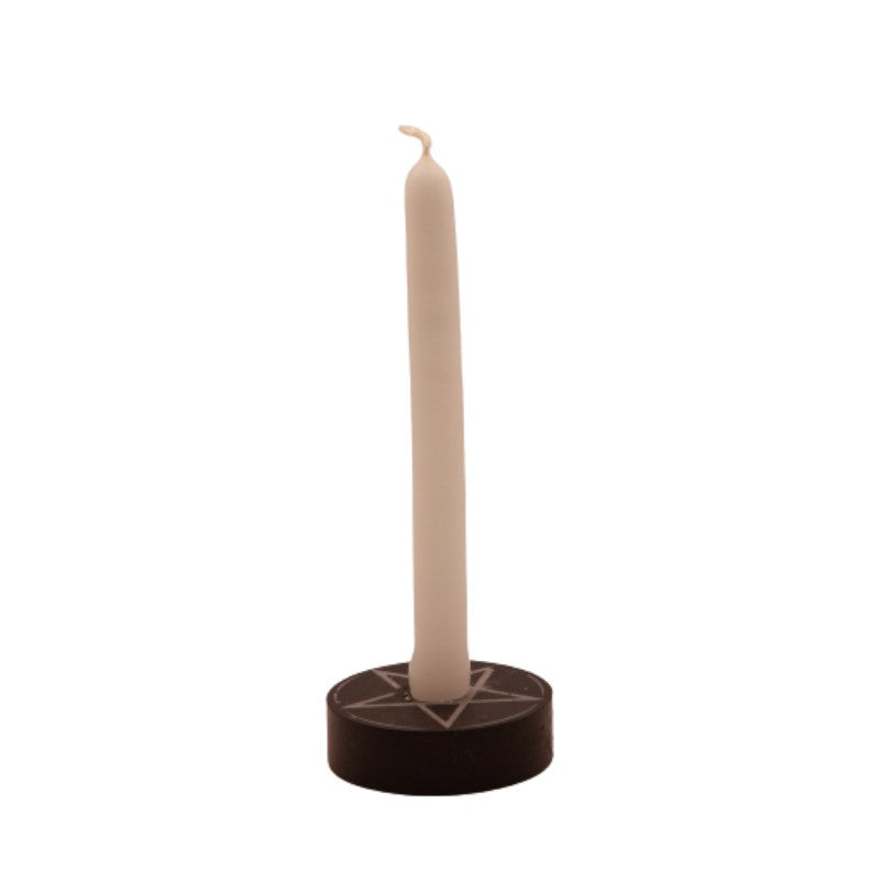 white  tiny taper candle in a pentacle candle holder