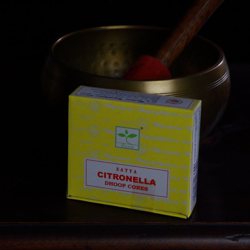 box of satya brand incense cones in front of a brass singing bowl