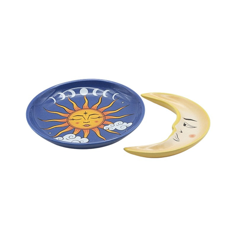 Two ceramic plates, one with a sun design and the other with a moon design, on a white background.