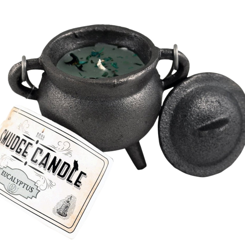 Green eucalyptus candle in a cast iron cauldron
