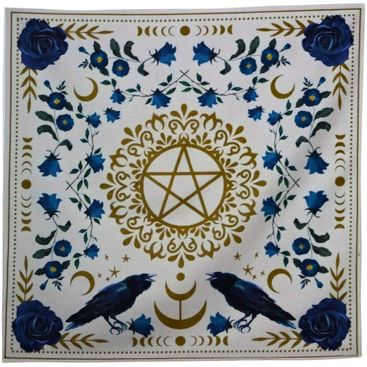 Tarot cloth. White with blue flowers surrounding a gold pentacle (5 pointed star surrounded by a circle). 2 ravens at the base of the pentacle.
